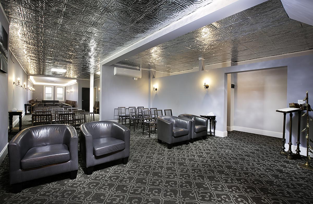 San Jose Funeral Home Chapel with four armrest chairs and registry stand